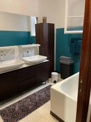 a bathroom with two sinks and a bath tub at Villa près de la Plage in Grosseto-Prugna