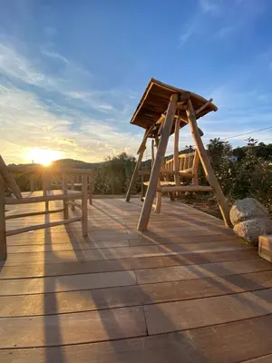 a wooden boardwalk with a slide on the sunset at Villa de charme avec piscine à Ajaccio in Alata