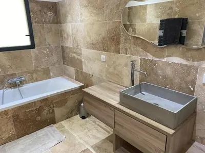 a bathroom with a sink and a bath tub at Villa de charme avec piscine à Ajaccio in Alata