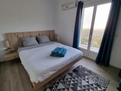 a bedroom with a bed and a large window at Casa Di Vadella in Santʼ Andrea-di-Cotone