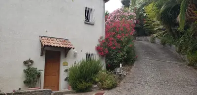 a white house with flowers on the side of it at Casa Di Vadella in Santʼ Andrea-di-Cotone