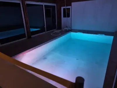 an empty swimming pool in a house at night at Casa Di Vadella in Santʼ Andrea-di-Cotone
