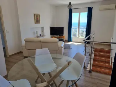 a living room with a couch and a table and chairs at Casa Di Vadella in Santʼ Andrea-di-Cotone