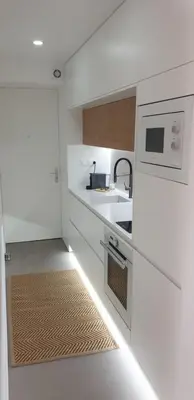 a white kitchen with a sink and a microwave at Destinu Marinella in Ajaccio