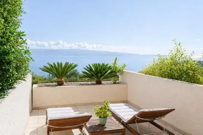 a small patio with two chairs and a table at Destinu Marinella in Ajaccio