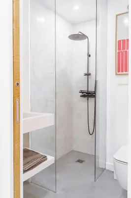 a bathroom with a glass shower with a sink and a toilet at Destinu Marinella in Ajaccio