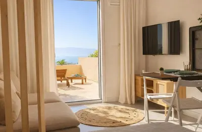 a living room with a table and a couch at Destinu Marinella in Ajaccio