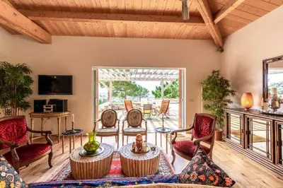 a living room with chairs and a table at Villa Pol & Dod - Piscine et vue sublime in Monacia-dʼAullène
