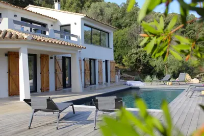 a house with a swimming pool next to a villa at Villa Pura Vida Di Olmuccio in Sainte-Lucie de Porto-Vecchio