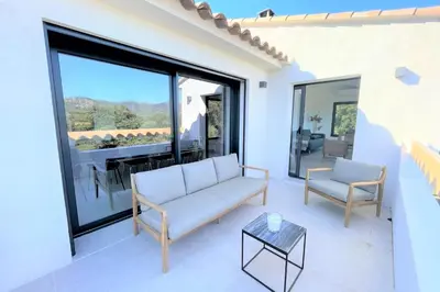 a living room with a couch and a table at Villa Pura Vida Di Olmuccio in Sainte-Lucie de Porto-Vecchio