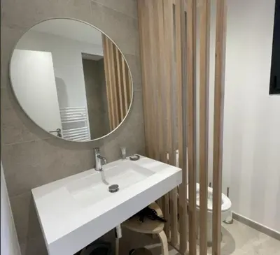 a bathroom with a white sink and a mirror at Villa Pura Vida Di Olmuccio in Sainte-Lucie de Porto-Vecchio