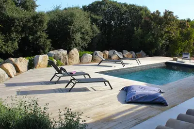 a pool with lounge chairs and a swimming pool at Villa Pura Vida Di Olmuccio in Sainte-Lucie de Porto-Vecchio