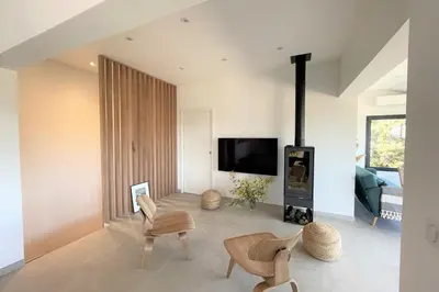 a living room with a fireplace and a tv at Villa Pura Vida Di Olmuccio in Sainte-Lucie de Porto-Vecchio