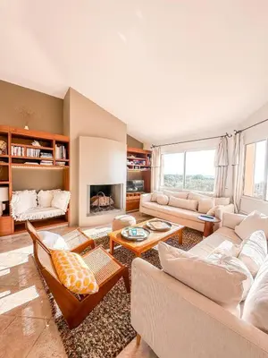 a living room filled with furniture and a fireplace at Villa Clementina Di Punta d'Arasu in Sainte-Lucie de Porto-Vecchio