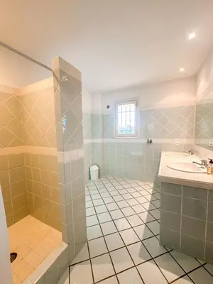 a large bathroom with a sink and a shower at Villa Clementina Di Punta d'Arasu in Sainte-Lucie de Porto-Vecchio