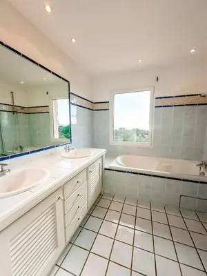 a bathroom with two sinks and a tub and a large mirror at Villa Clementina Di Punta d'Arasu in Sainte-Lucie de Porto-Vecchio