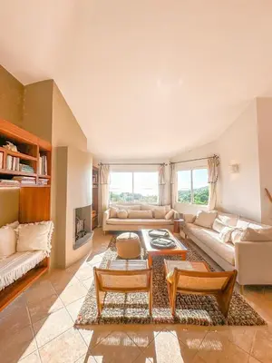 a living room with a couch and a table at Villa Clementina Di Punta d'Arasu in Sainte-Lucie de Porto-Vecchio