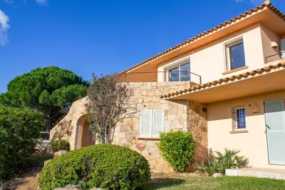 a house with a stone facade and bushes at Villa Clementina Di Punta d'Arasu in Sainte-Lucie de Porto-Vecchio