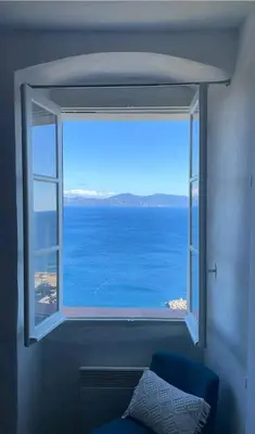 a window with a view of the ocean at Appartement Vue mer en plein centre de Cargese in Cargèse