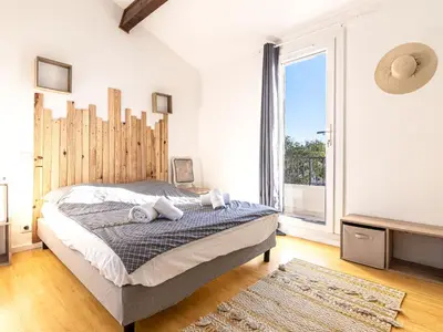 a bedroom with a bed and a large window at Holiday Home Villa Vaccaja by Interhome in Porto-Vecchio