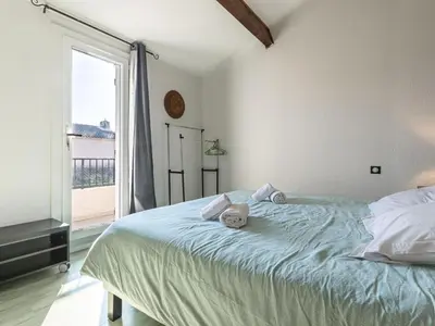 a teddy bear laying on a bed in a bedroom at Holiday Home Villa Vaccaja by Interhome in Porto-Vecchio