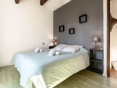 a bedroom with a bed with white sheets and pillows at Holiday Home Villa Vaccaja by Interhome in Porto-Vecchio
