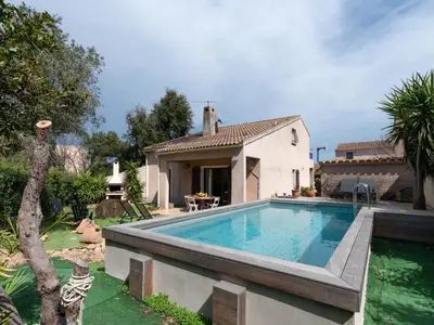 a swimming pool in front of a house at Holiday Home Villa Vaccaja by Interhome in Porto-Vecchio