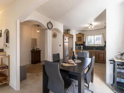 a kitchen and dining room with a table and chairs at Holiday Home Villa Vaccaja by Interhome in Porto-Vecchio