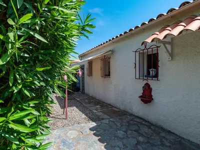 a white house with a red fire hydrant on the side at Holiday Home Villa Irène by Interhome in Linguizzetta
