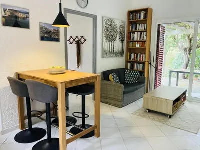 a living room with a wooden table and chairs at Holiday Home Villa Irène by Interhome in Linguizzetta