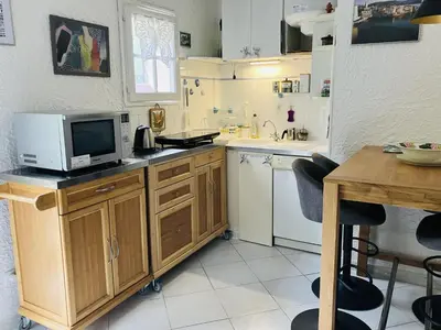a kitchen with a microwave and a tv on a counter at Holiday Home Villa Irène by Interhome in Linguizzetta