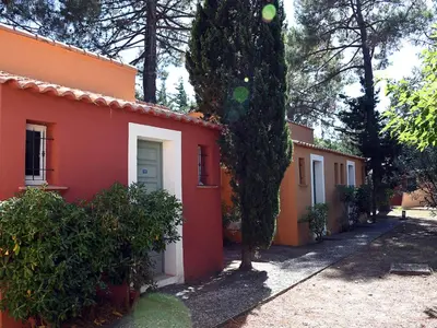 an orange and white house with a tree next to it at Holiday Home Studio cabine Type B by Interhome in Borgo