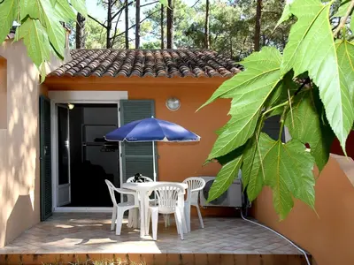 a patio with a table and chairs and an umbrella at Holiday Home Studio cabine Type B by Interhome in Borgo