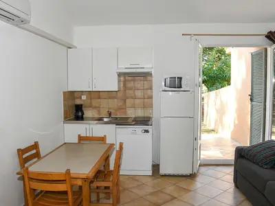 a kitchen and dining room with a table and a refrigerator at Holiday Home Studio cabine Type B by Interhome in Borgo