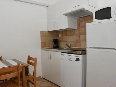 a kitchen with a white refrigerator and a table at Holiday Home Studio cabine Type B by Interhome in Borgo