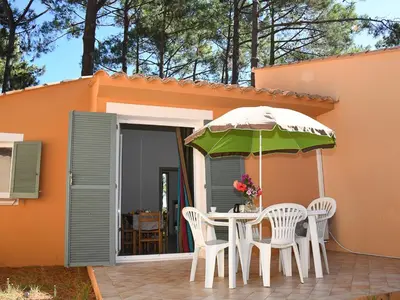 a table and chairs with an umbrella on a patio at Holiday Home T2 Cabine Type C by Interhome in Borgo