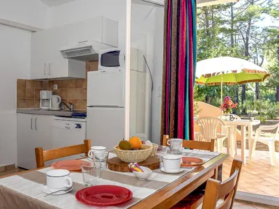 a kitchen and dining room with a table with a tableablish at Holiday Home T2 Cabine Type C by Interhome in Borgo
