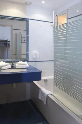 a bathroom with a tub and a sink and a mirror at Holiday Home T3 Cabine by Interhome in Borgo