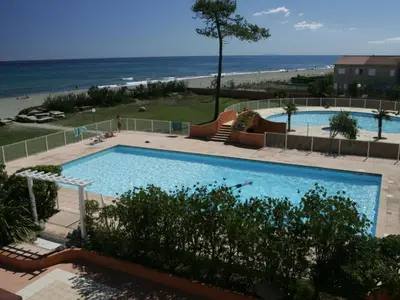 a swimming pool with the beach in the background at Holiday Home T3 Cabine by Interhome in Borgo