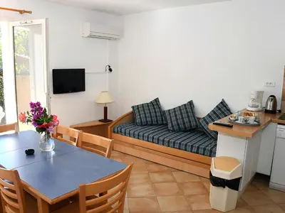 a living room with a couch and a table at Holiday Home T3 Cabine by Interhome in Borgo