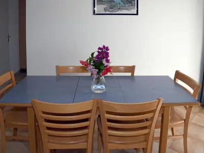 a blue table with a vase of flowers on it at Holiday Home T3 Cabine by Interhome in Borgo