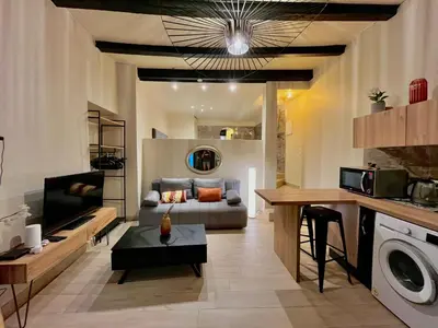 a living room with a couch and a table at Beau F2 centre ville in Ajaccio