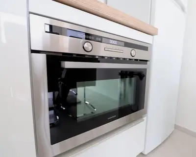 a kitchen with a concrete counter and a dining room at T3 Acum - Domaine prestigieux sur Agosta plage - Exceptionnel 3 étoiles in Porticcio
