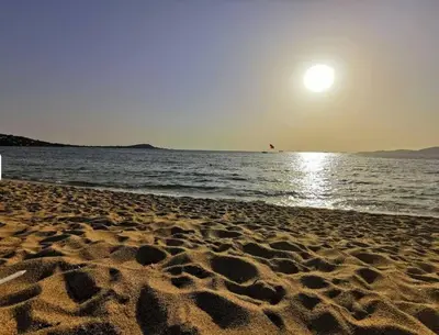 a beach with the sun rising over the water at T3 Acum - Domaine prestigieux sur Agosta plage - Exceptionnel 3 étoiles in Porticcio