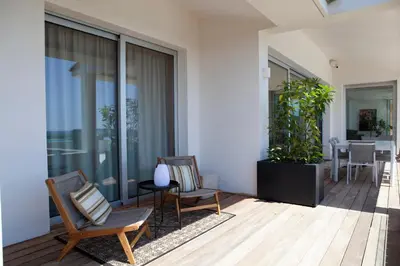a patio with two chairs and a table at Porto-Vecchio Palombaggia Villa Azaïtù in Porto-Vecchio