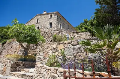 a stone building on top of a stone wall at A Vignarella in Ventiseri