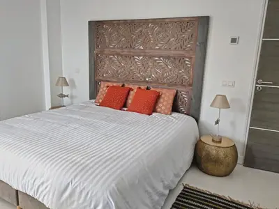 a bedroom with a large bed with orange pillows at A Vignarella in Ventiseri