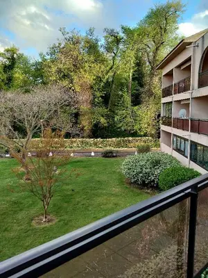 a view from a balcony of a building and a yard at MORIANI STUDIO CABINE CLIMATISE 4 à 5 pers in San-Nicolao