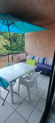 a room with a table and chairs and a couch at MORIANI STUDIO CABINE CLIMATISE 4 à 5 pers in San-Nicolao