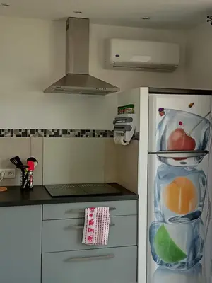 a kitchen with a refrigerator filled with fruits and vegetables at Un Nid Douillet en bord de plage !! in Lucciana